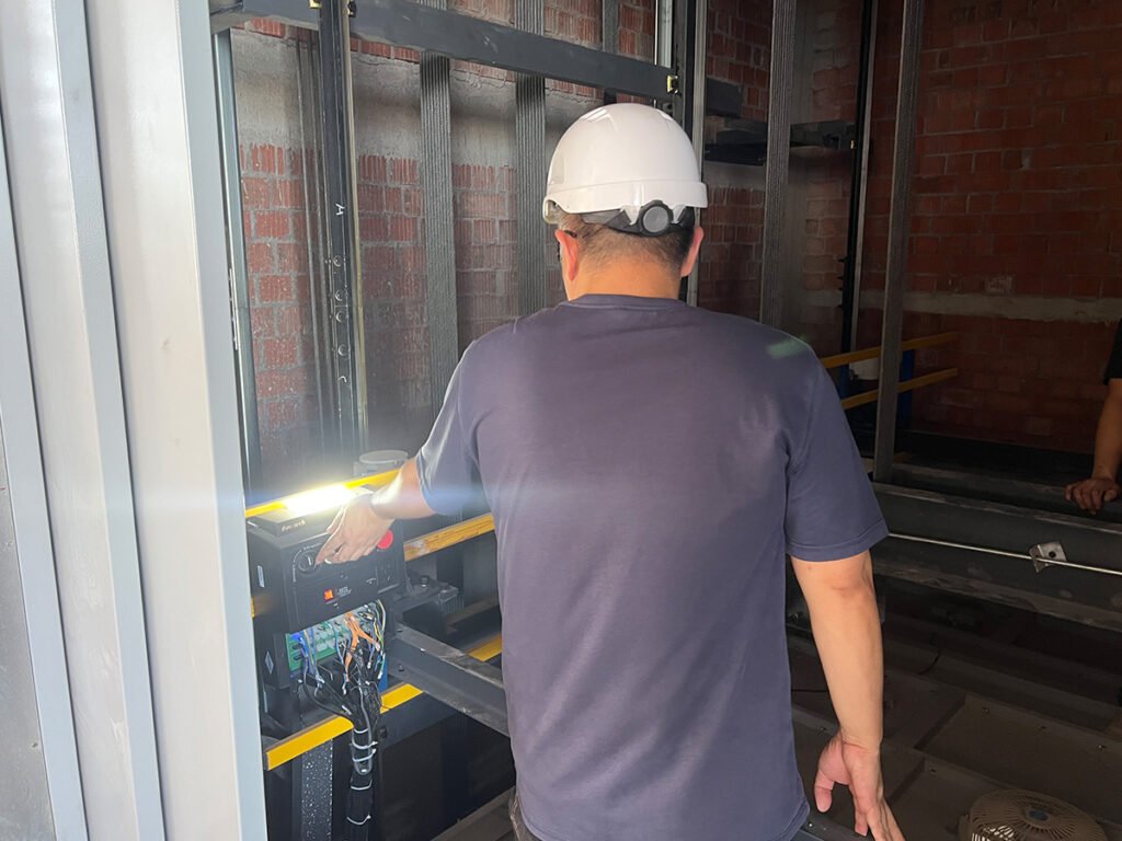 FEIYA technician performing freight elevator inspection and testing
