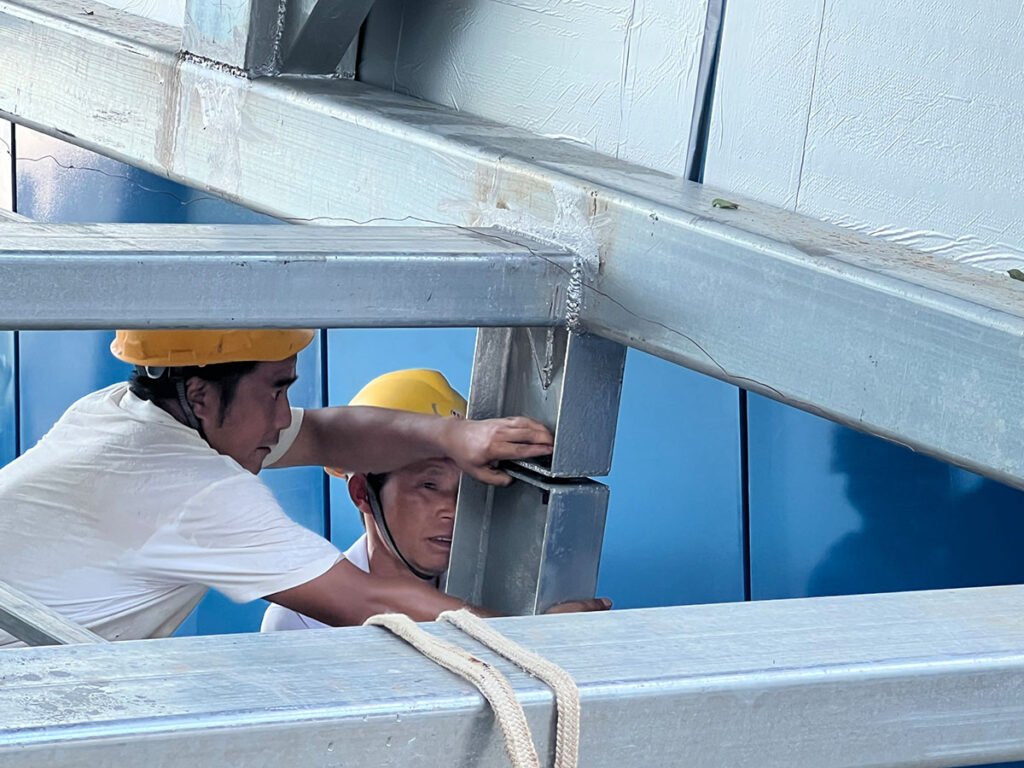 FEIYA technicians assembling freight elevator components and systems